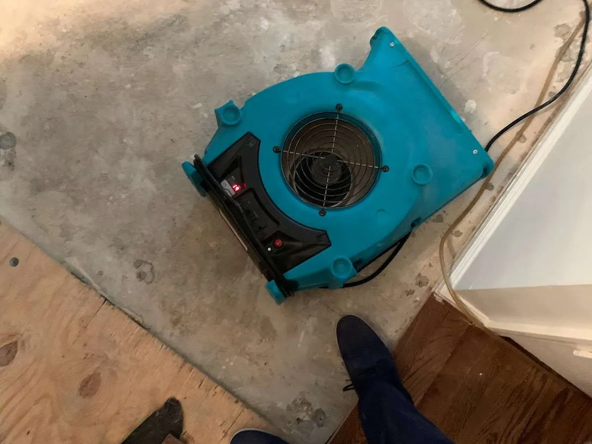 Air mover drying subfloor during Commercial Water Damage Restoration in Mead Valley